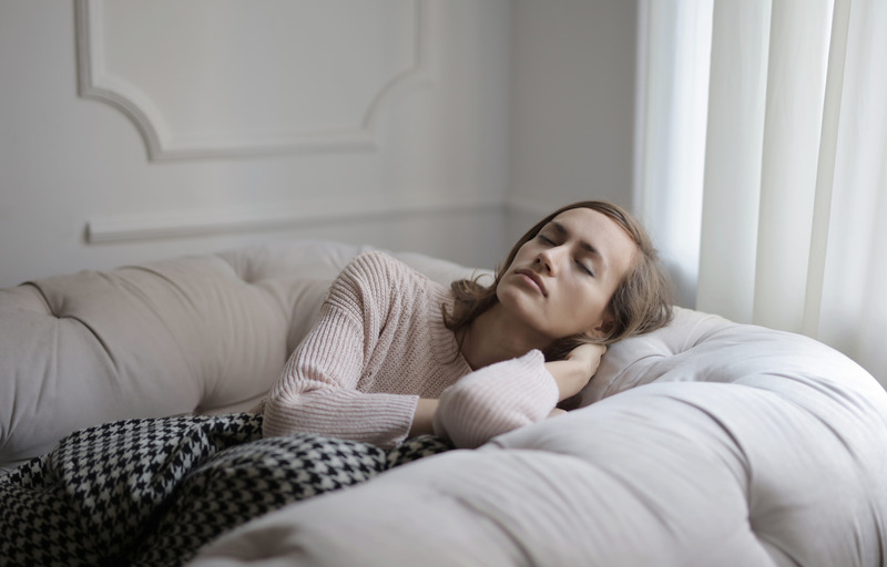 A woman relaxes on a couch