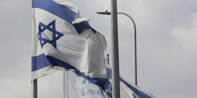 Israeli flag on a pole waving in the breeze