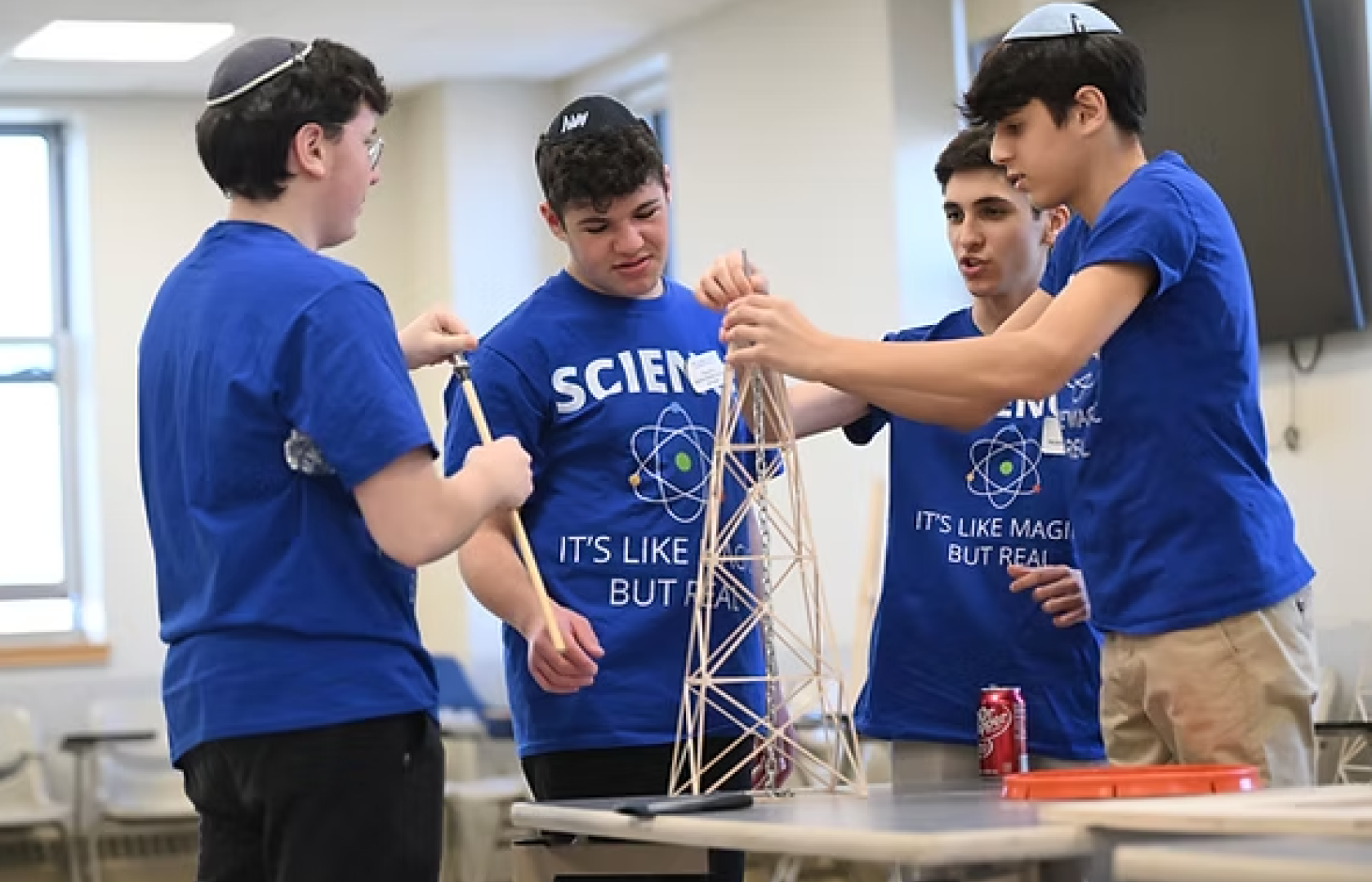Four yeshiva boys work on a science project 