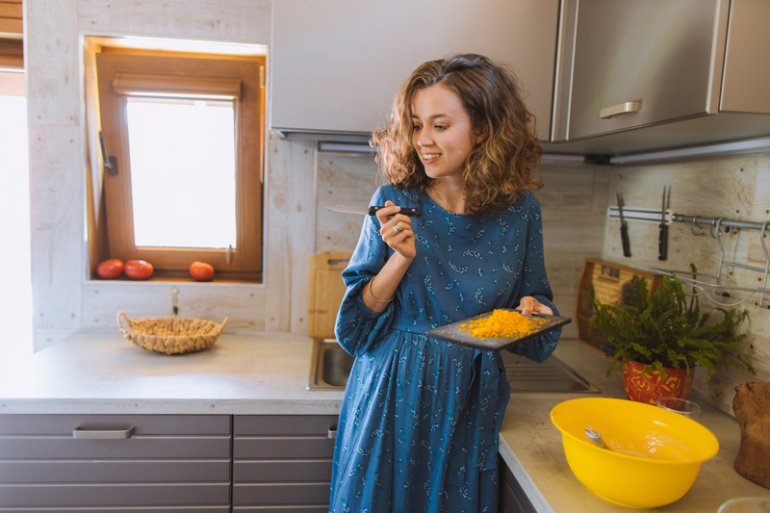 A woman making food in a kitchen 