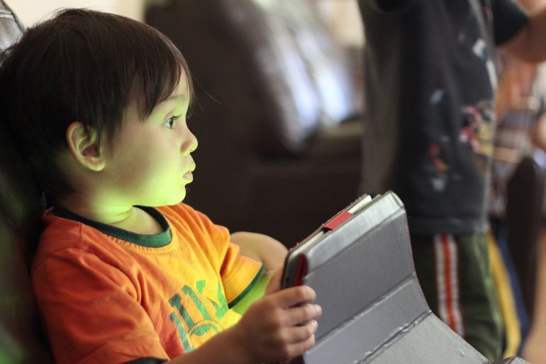 Child playing with a tablet