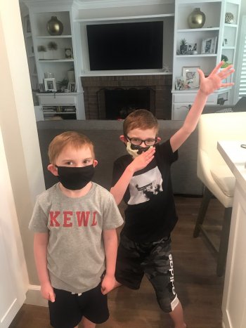 Two children wearing masks