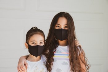 Two little girls wearing masks