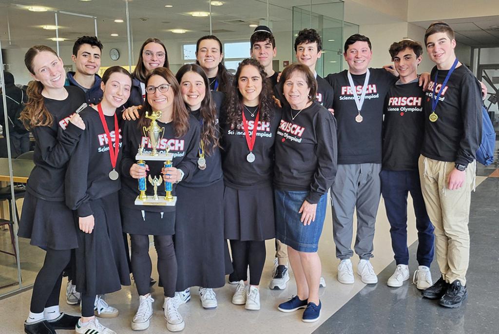 a group of orthodox teens smile and pose with trophies