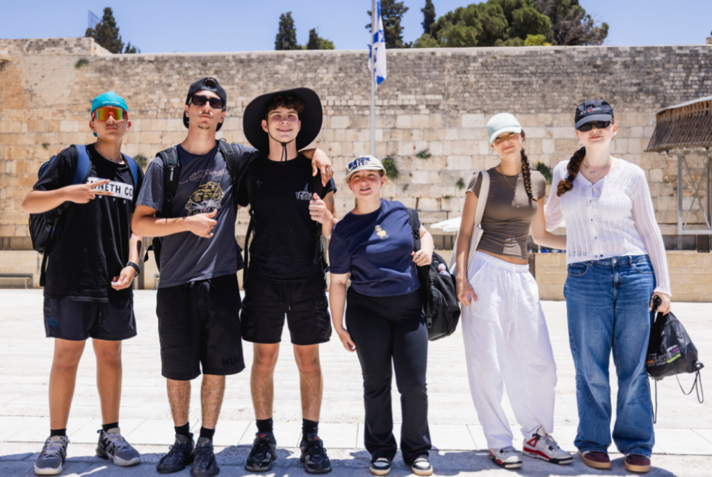 Boys and girls pose at the Kotel