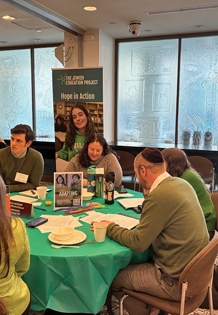 A group of educators sits at a table