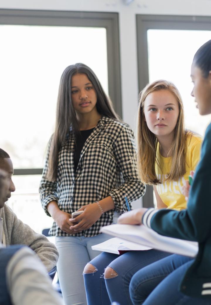 Teens talking in a classroom