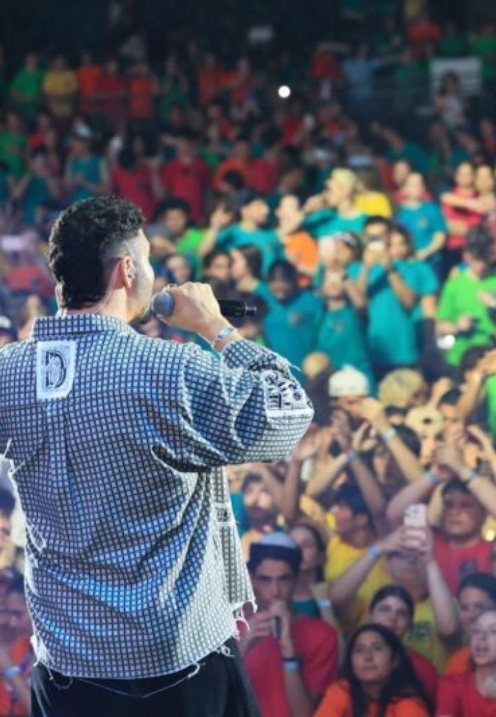 a singer sings to a crowd of teens