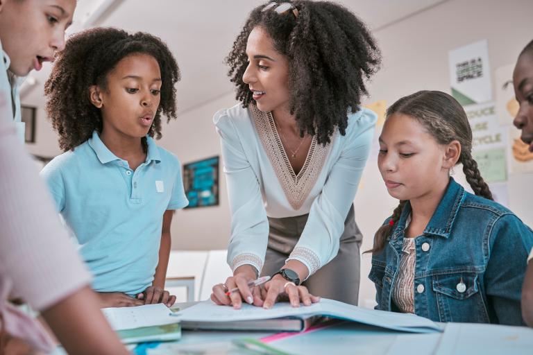 a teacher helps a students