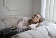 A woman relaxes on a couch