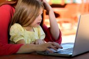 Child on Parents Lap with Computer